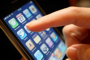 The logo of social networking website Twitter is seen displayed on the screen of an iPhone smartphone.