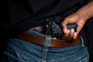 A man with a gun tucked into his pants