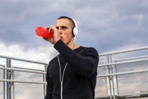 sporty young man drinking energy drink