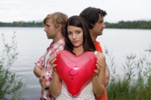 Young woman with heart-shaped balloon