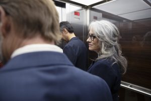 Businesswoman riding in elevator