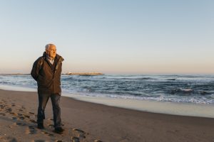 Senior man strolling at the beach