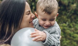 Happy mother and little boy with a balloon
