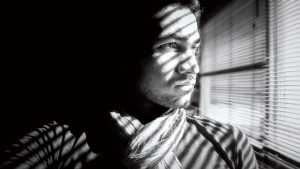 Man Looking Out Window