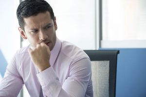 Businessman looking away concerned