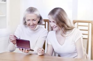 señora madre e hija jugando a videojuegos