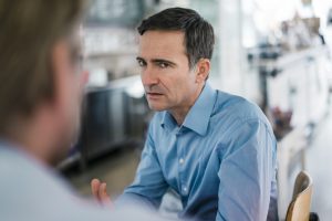 Portrait of serious businessman looking at colleague