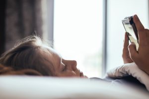 Woman watching news on at smart device.