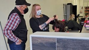 Hombre aprende a hacer rizos en la peluquería