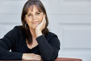 Middle Aged Woman Smiling with Hands on Cheeks