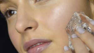 Close-up of young woman doing ice treatment