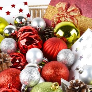 Gifts And Christmas Decorations In Basket Over White Background