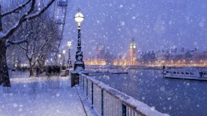 Snowing on Jubilee Gardens in London at dusk
