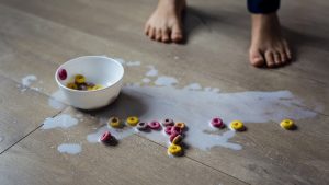Spilled bowl of milk and cereal