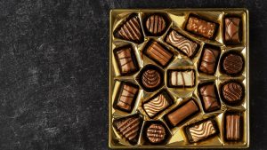 Box of chocolates on black background