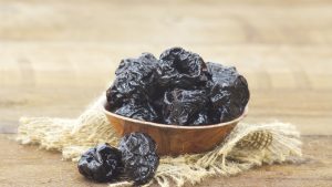 Close-up of Bowl full of dried plums on table