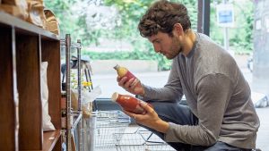Young man shopping in food store.