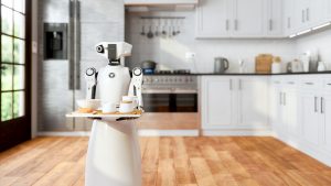 Robot Maid Holding A Tray And Serving Food And Drink In Modern Domestic Kitchen With Blurred Background. Artificial Intelligence And Smart Robotics Concept.