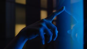 close up view of woman hand using interactive touchscreen display of electronic kiosk