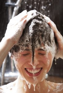 Womn washing hair in shower