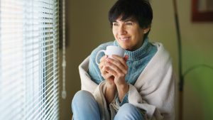 Portrait Of Young Woman Drinking Coffee At Home