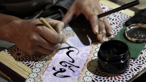Close-up of Man Writing Arabic Calligraphy