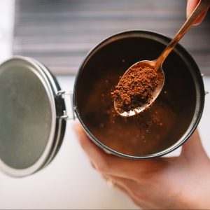 Cropped Hands Of Woman Scooping Ground Coffee From Reusable Container, Lleida, Spain