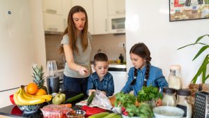 Children helping their mother to prepare healthy meal