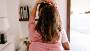 Man taking off female partner's sweater at home