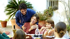 Cheerful family enjoying at outdoor meal table