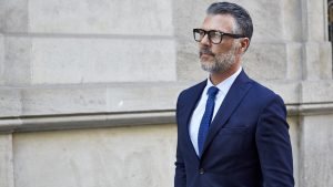 Thoughtful businessman against building