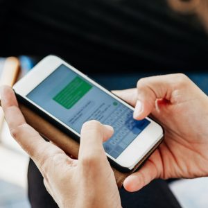 Close Up Of Woman Messaging Friends Using Smartphone