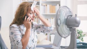 Woman suffers from heat in the office or at home