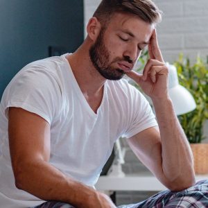 Young man feels pain in the head and fever