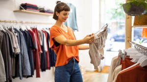 Young woman shopping at clothing store