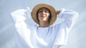Portrait of smiling young woman wearing straw hat