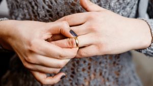 woman takes off an engagement ring, family conflict,  close-up