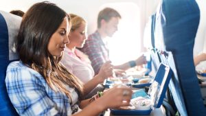 Passengers having lunch while traveling by airplane.