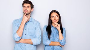 Portrait of his he her she nice-looking attractive lovely charming cheerful bewildered suspicious couple partners wearing casual creating idea isolated over light white pastel color background