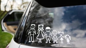 Happy family on board. Sticker on the back of car. Four kids.
