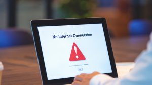 Businessman looking at an internet failure screen on a computer.