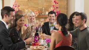 Friends toasting at dinner party