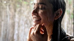 Headshot, hispanic woman taking a shower