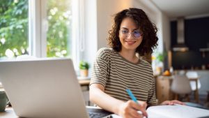 Young woman, a university student, studying online.