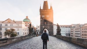 Rear view of a man walking on the Charles Bridge in Prague, Czech Republic