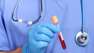 Doctor holding blood in test tube