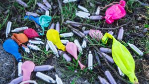 metal bulbs laughing gas and balloons in grass field