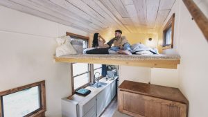 Young couple in bedroom loft of tiny house