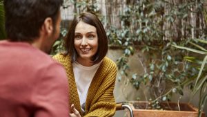 Smiling woman looking at man in yard