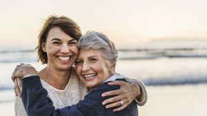 Portrait of happy daughter embracing senior woman